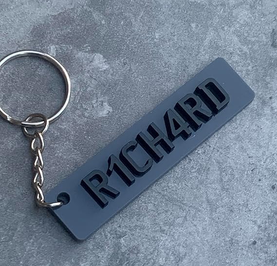 Personalised car number plate keyring with custom name or registration.